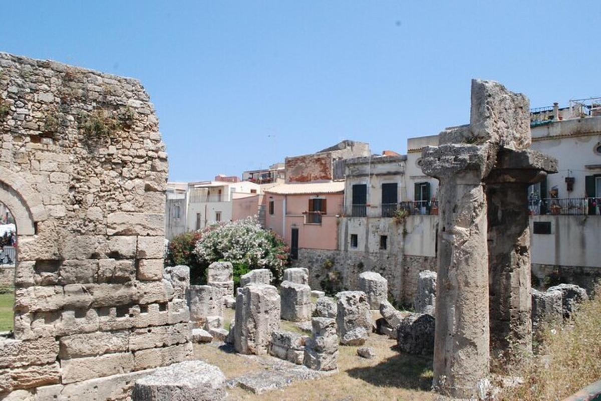 un grup de ruïnes amb edificis al fons