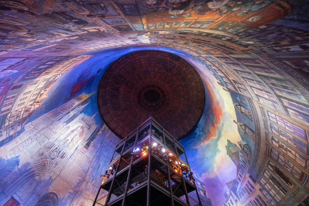 a room with a painting on the ceiling of a building