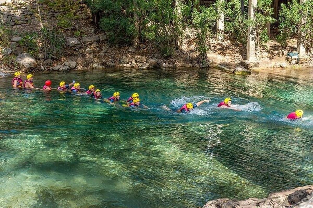 a group of people in the water on a river