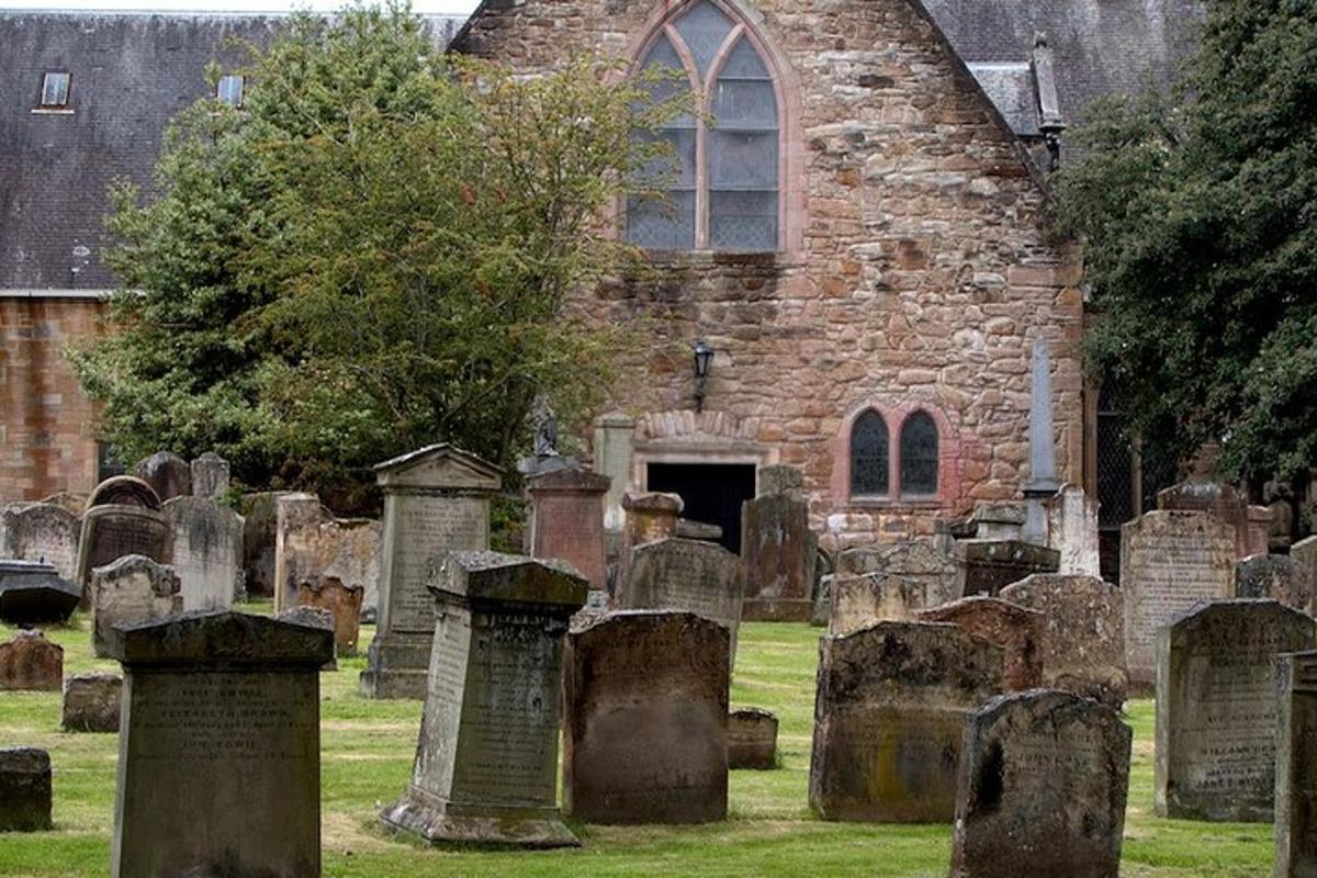 an old stone church with a bunch of cemetery