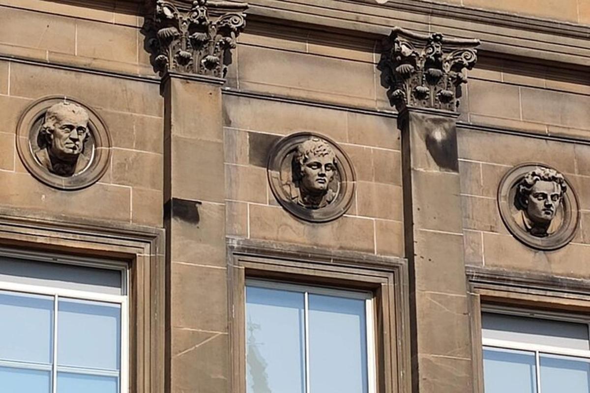 a building with busts of faces on the side of it