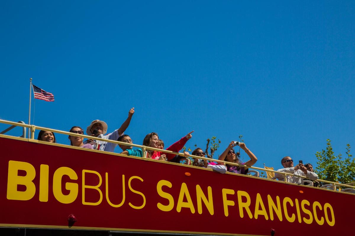 a group of children riding on top of a roller coaster