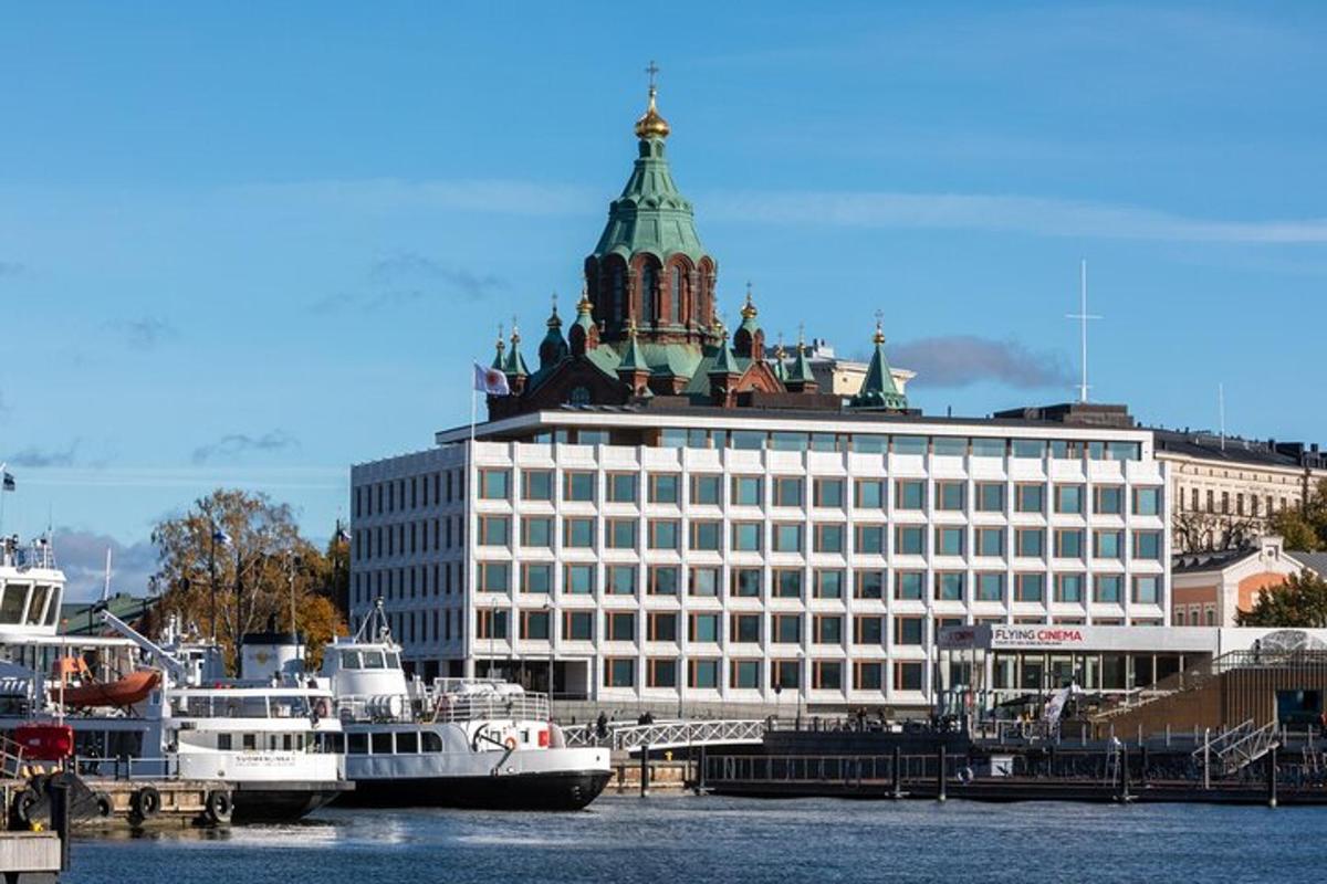 a large white building with a green dome on top