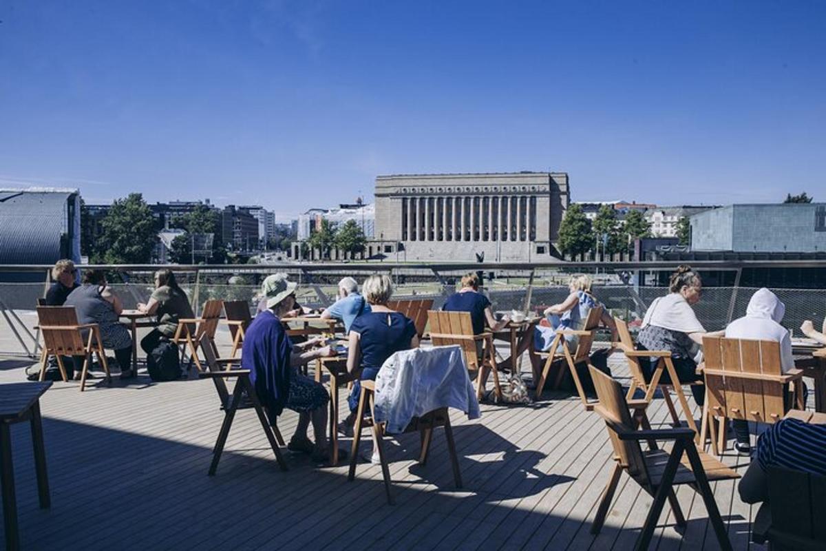 a group of people sitting at tables on a deck