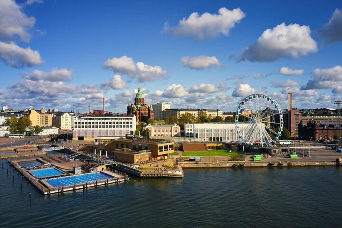 a city with a ferris wheel next to the water