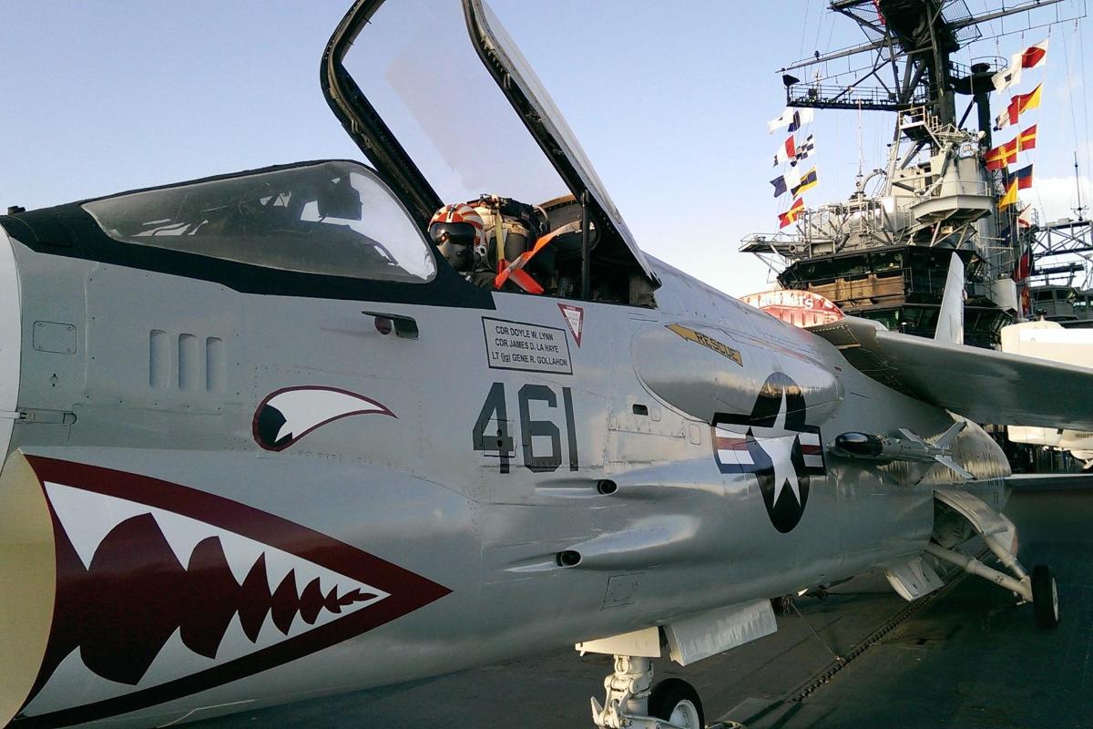 a fighter jet sitting on top of a ship