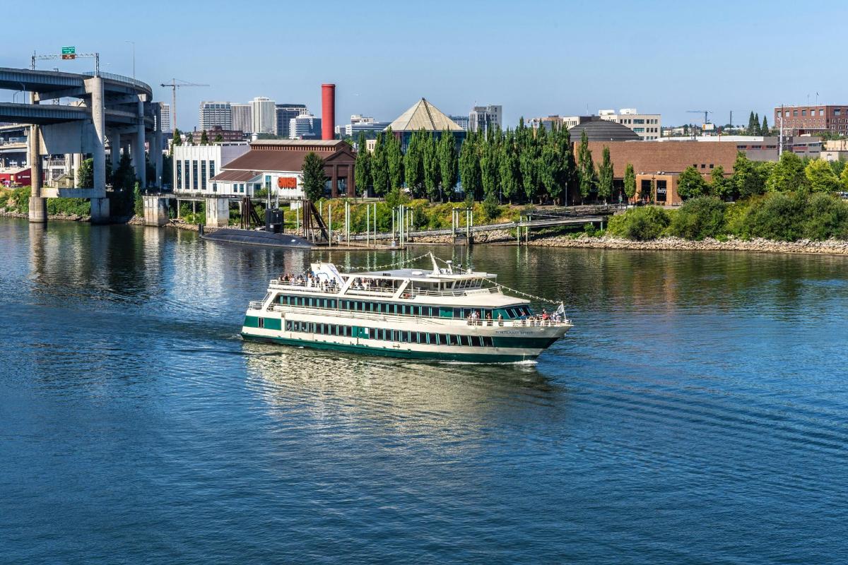 a boat on a river with a city in the background