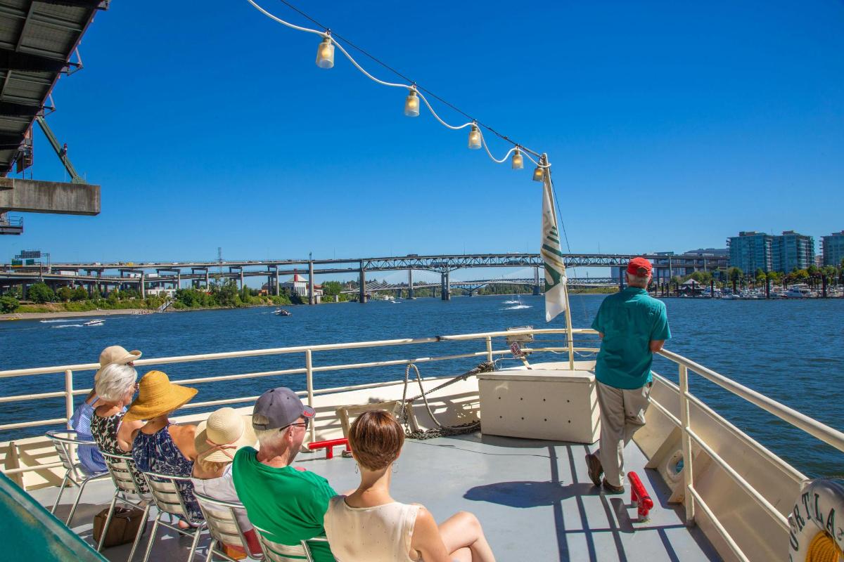 a group of people sitting on a boat on the water