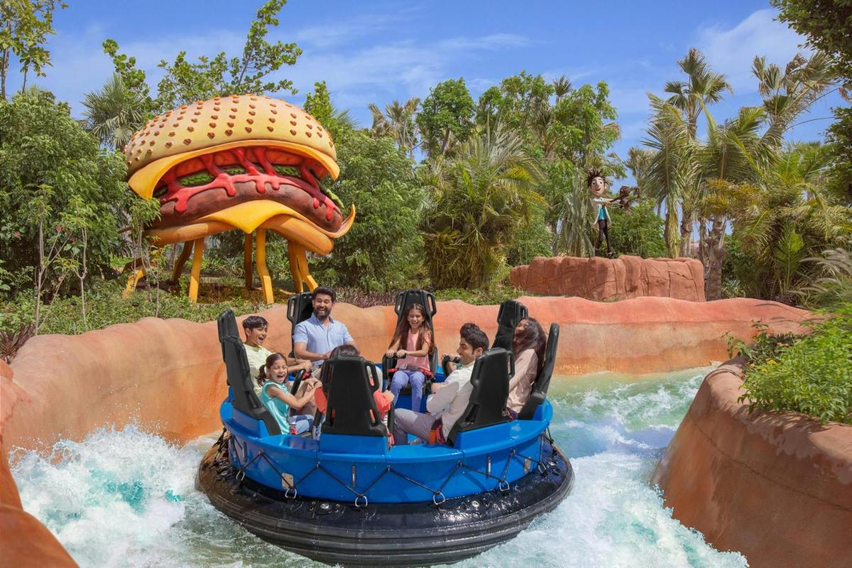 a group of people riding on a water slide at a water park