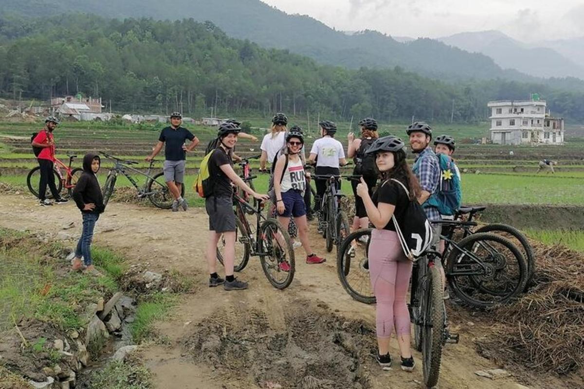 un gruppo di persone con le biciclette su una strada sterrata
