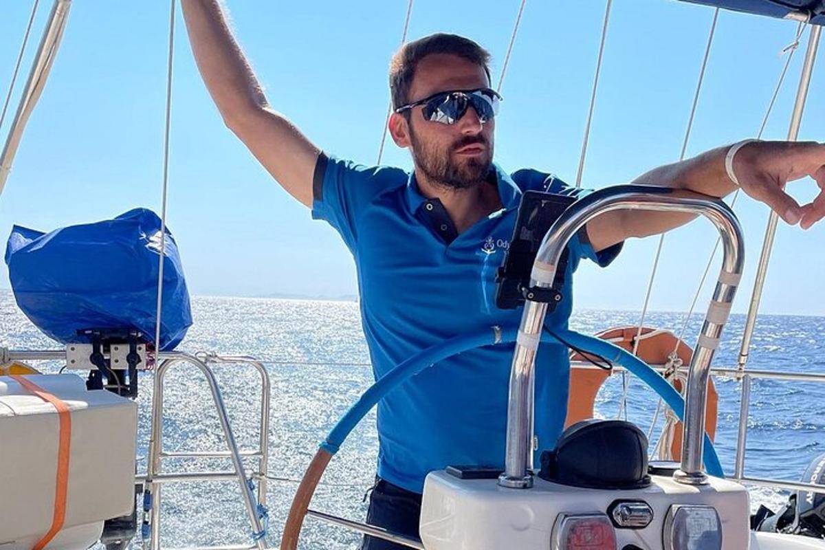 a man on a boat with his arms in the air