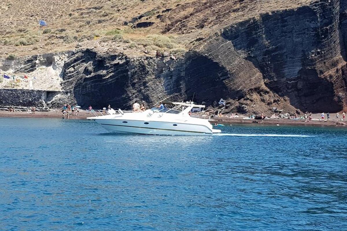 um barco branco na água perto de uma praia