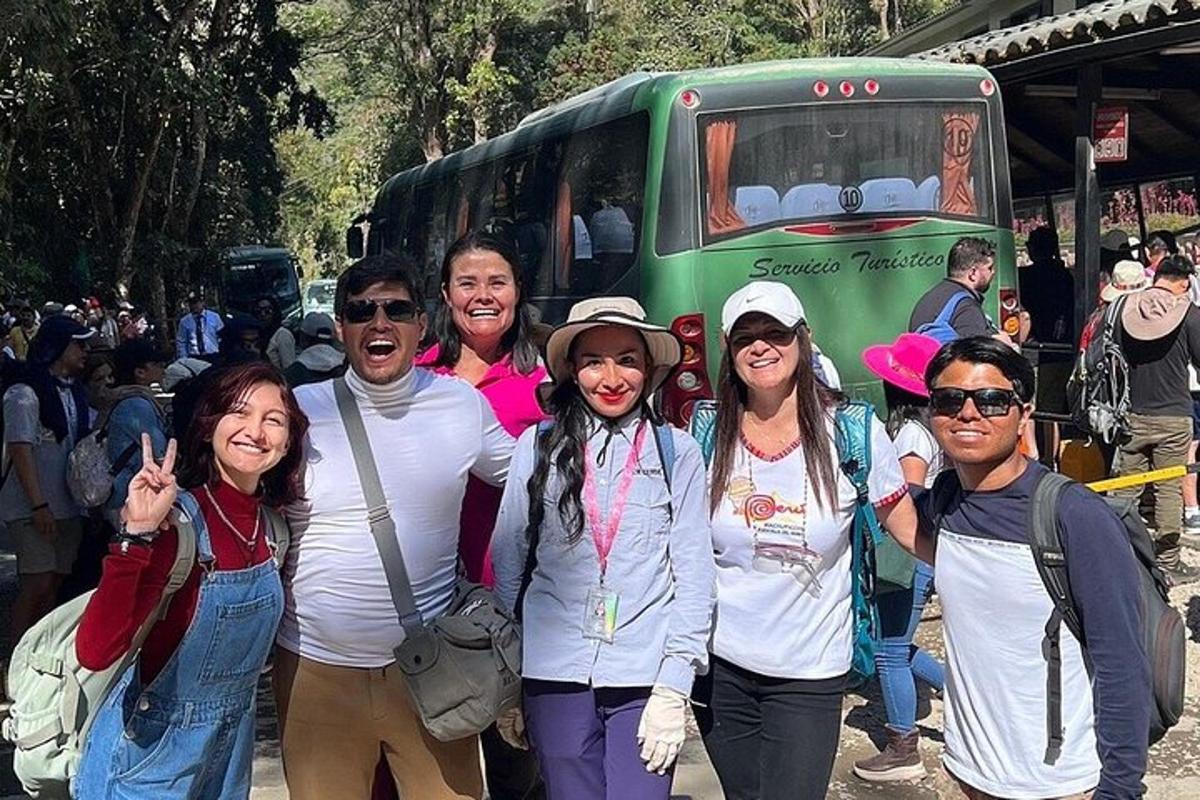 a group of people standing in front of a bus