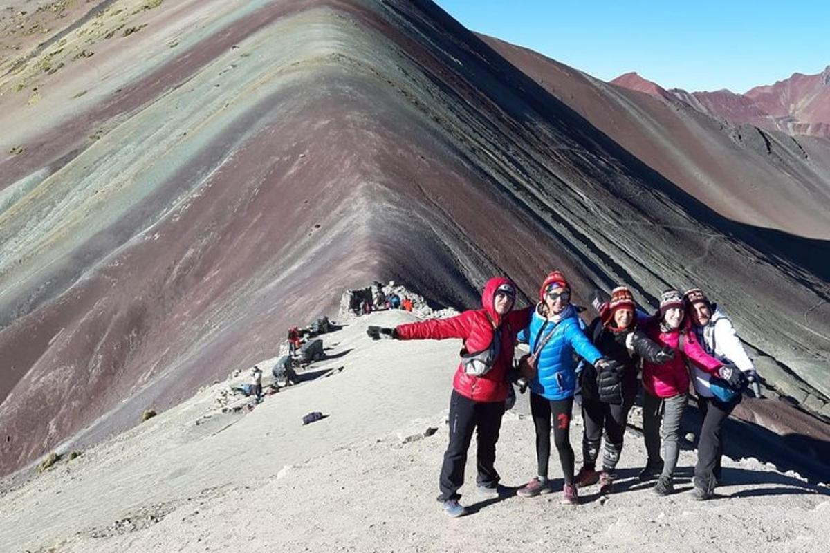 een groep mensen die op de top van een berg staat