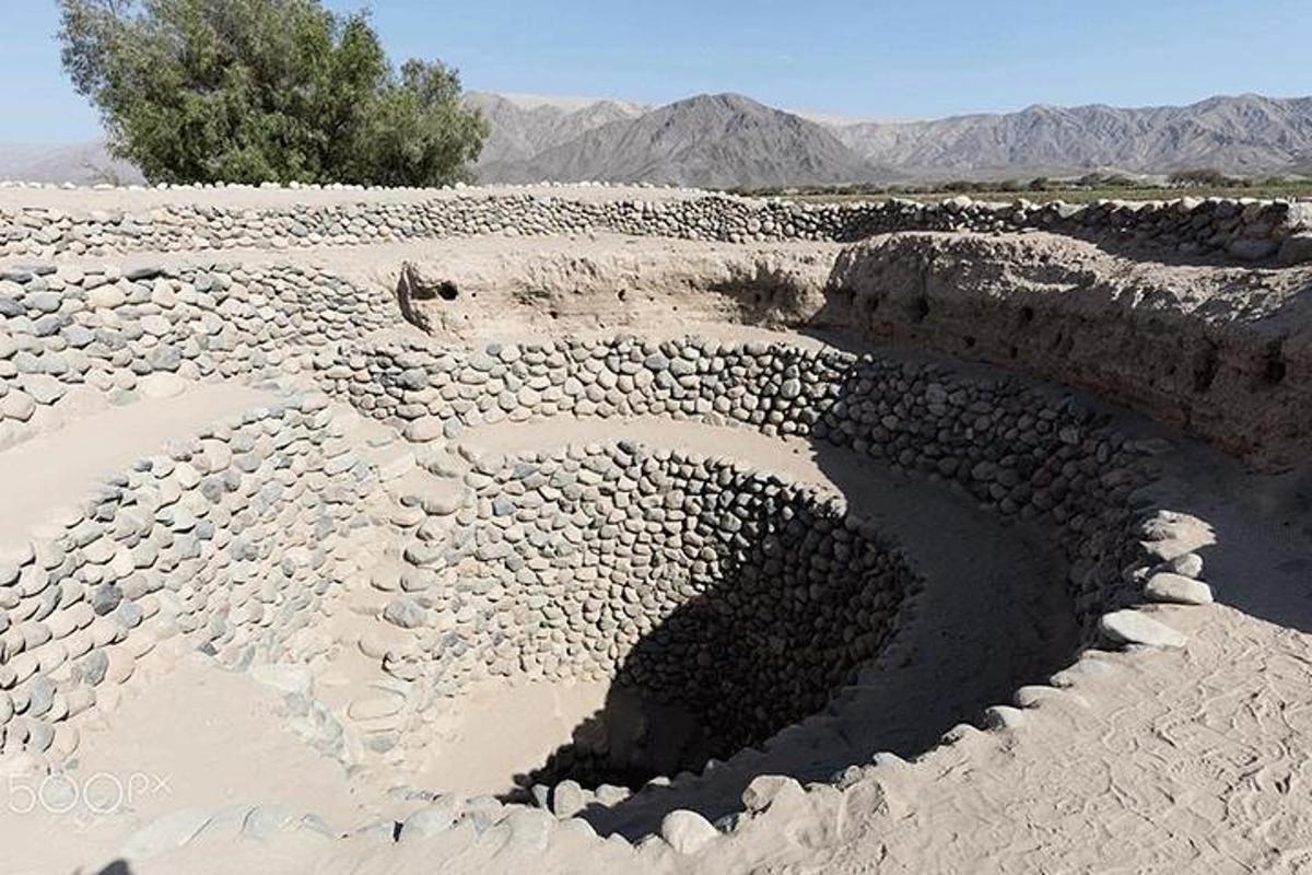a hole in the ground in the desert