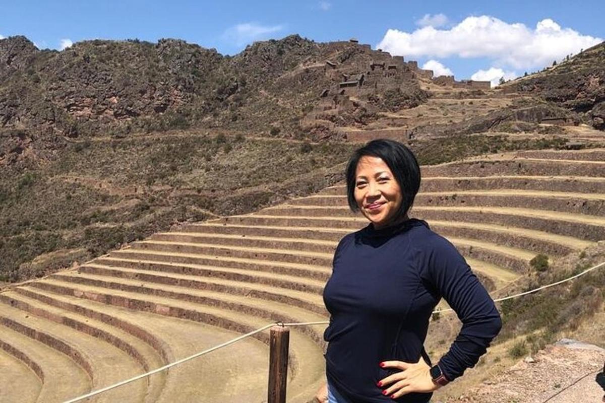 a woman standing in front of a set of stairs