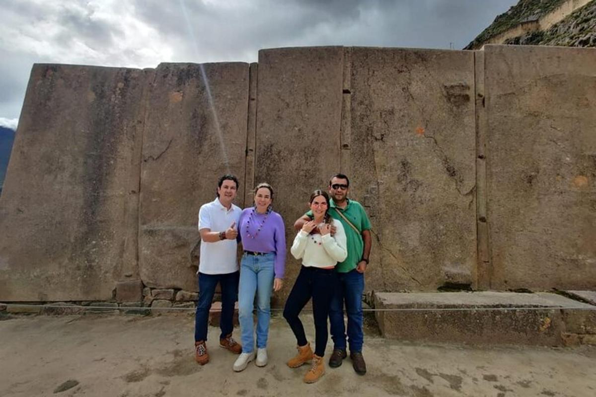 a group of people standing in front of a wall