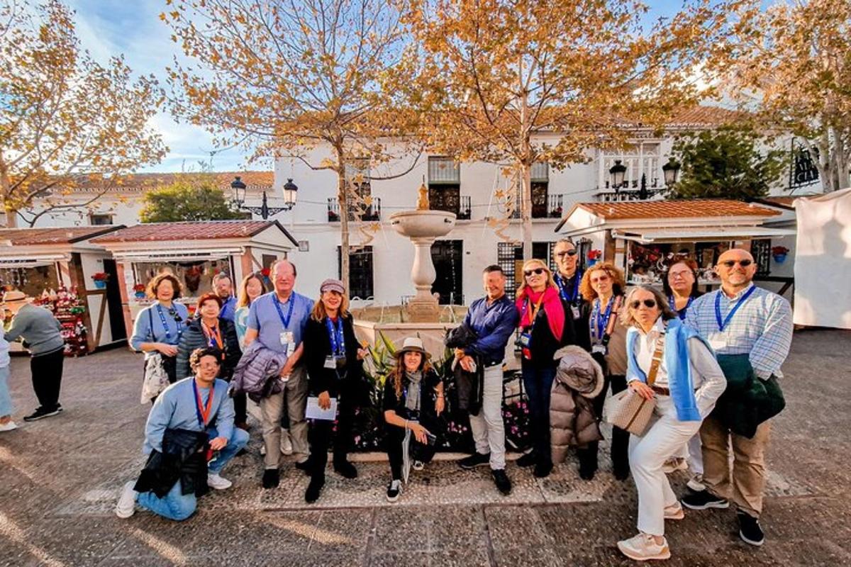 a group of people posing for a picture in front of a building