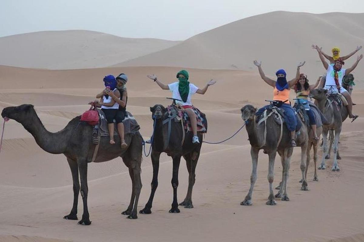 un grupo de personas en camellos en el desierto