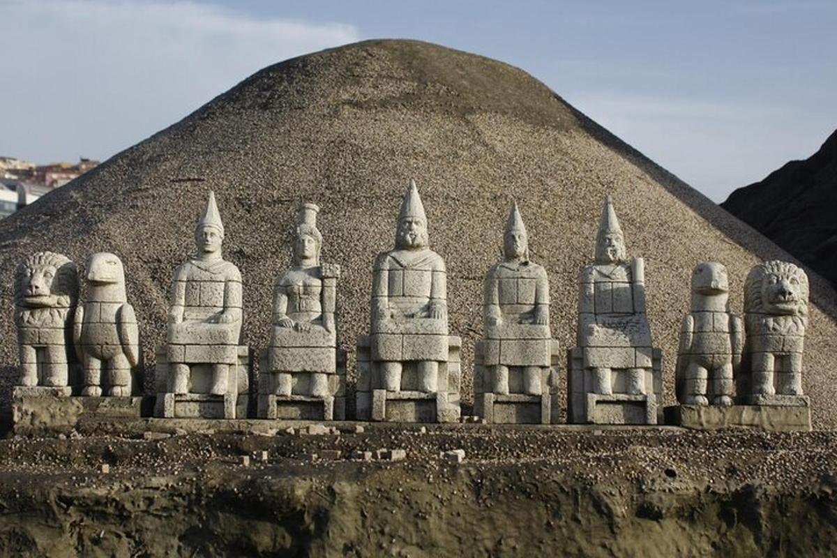 a sand sculpture of a group of people in front of a pyramid
