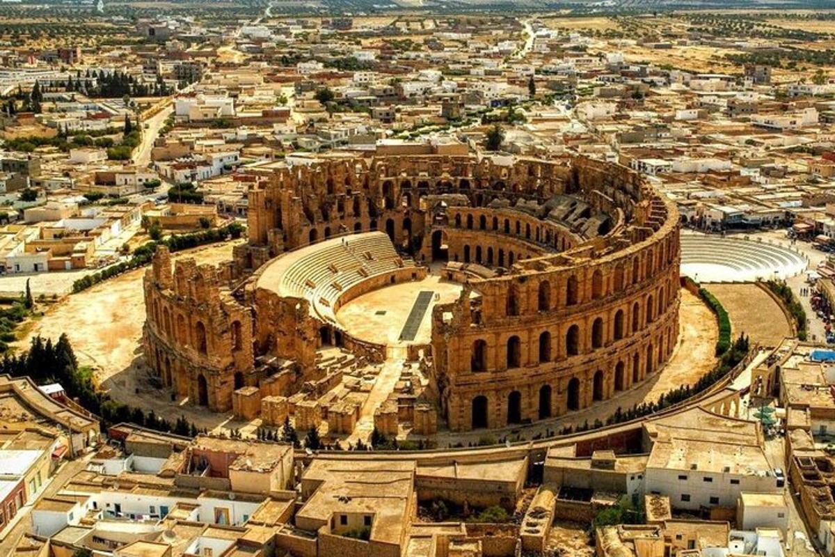 an aerial view of the colosseum and a city