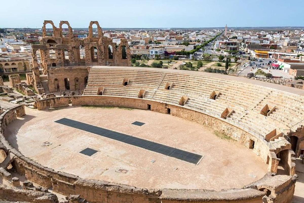 an empty amphitheater with a city in the background