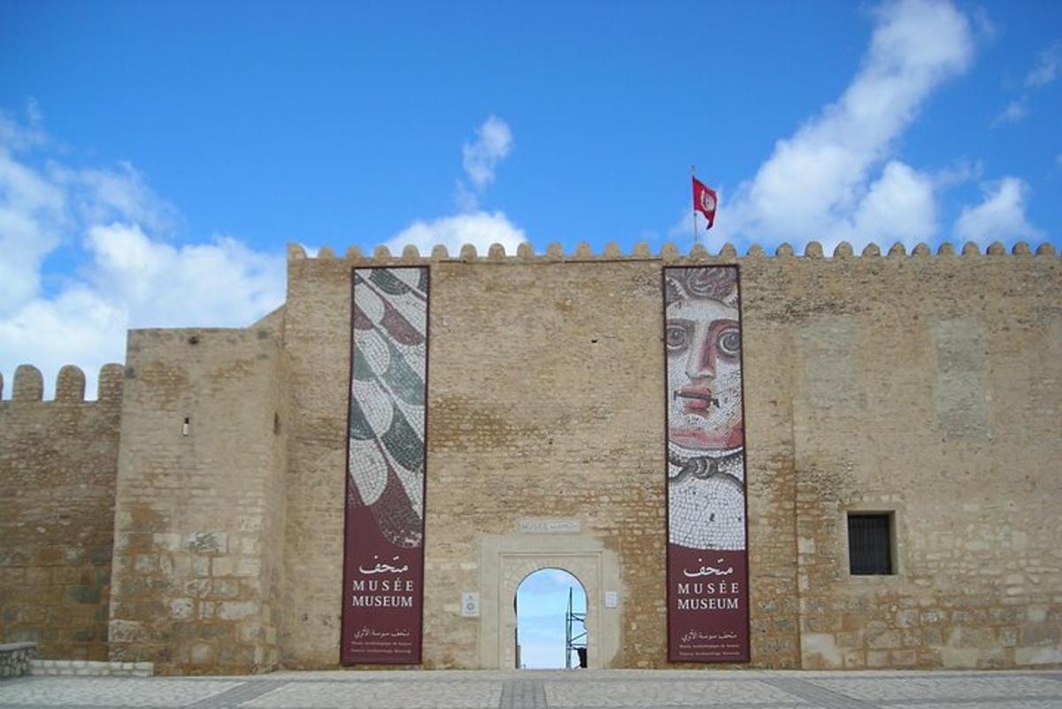 a large brick building with two posters on it