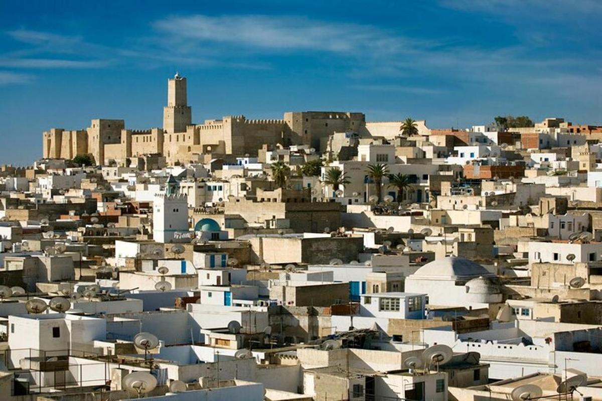 a city with white buildings on a hill