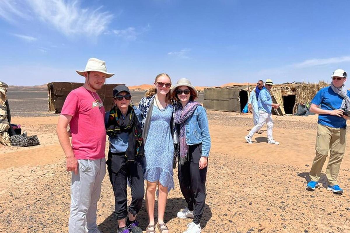 a group of people posing for a picture in the desert