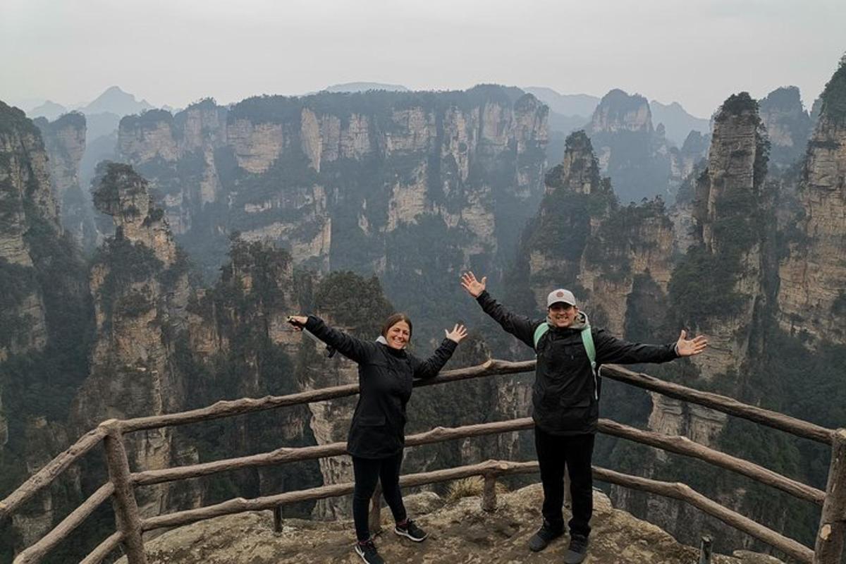 a man and woman standing on the edge of a mountain