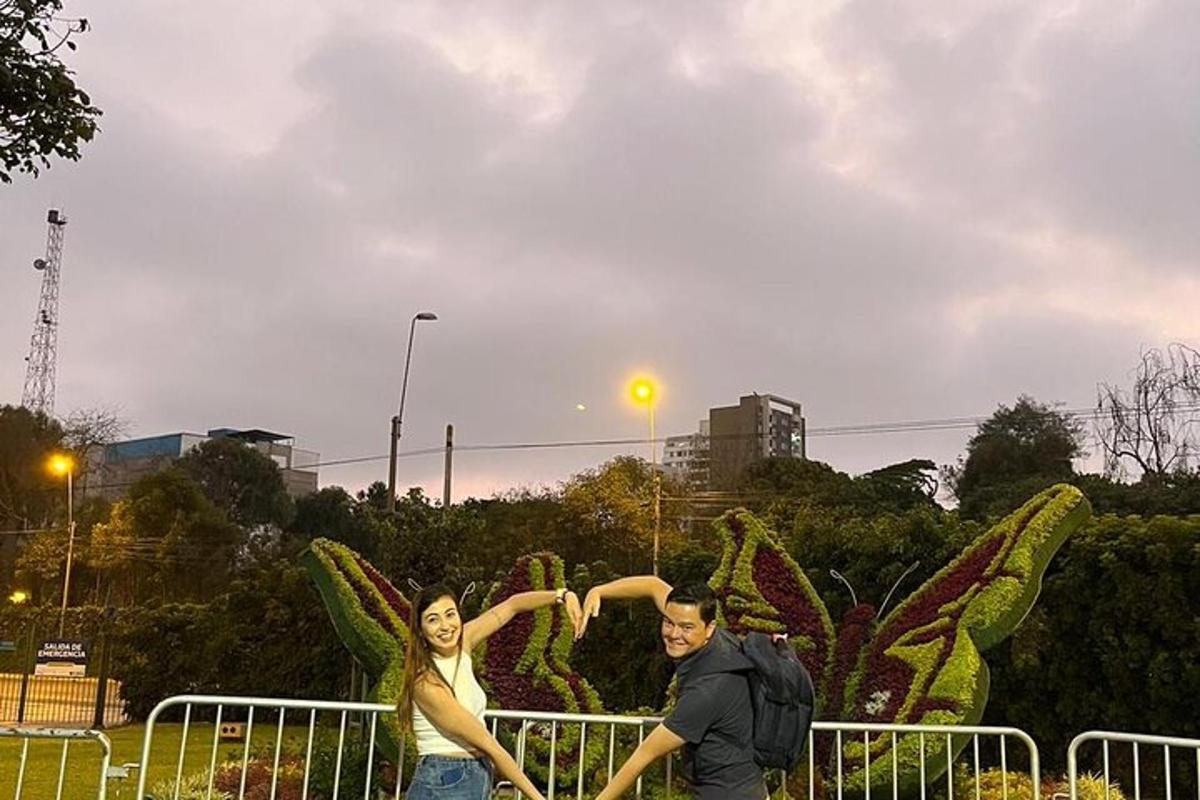 a man and a woman standing in front of a cactus
