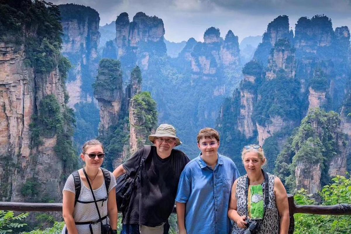 a group of people standing in front of a mountain