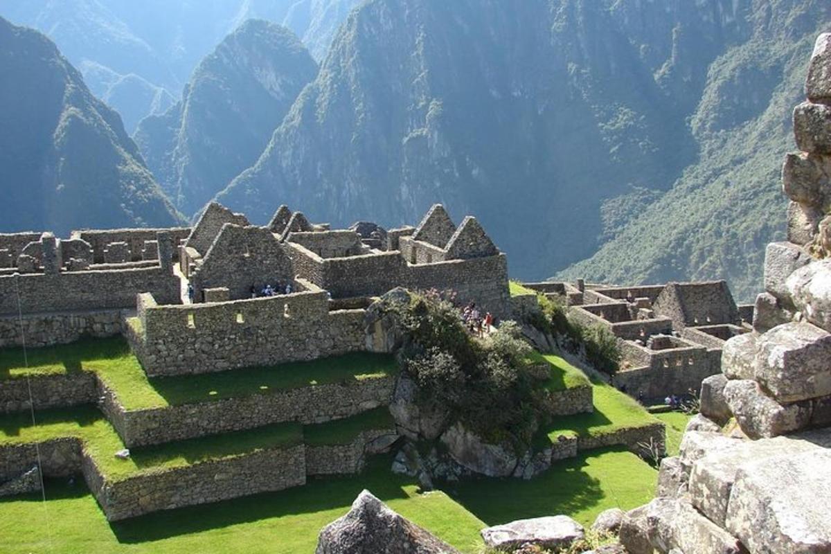 um grande edifício de pedra com montanhas ao fundo