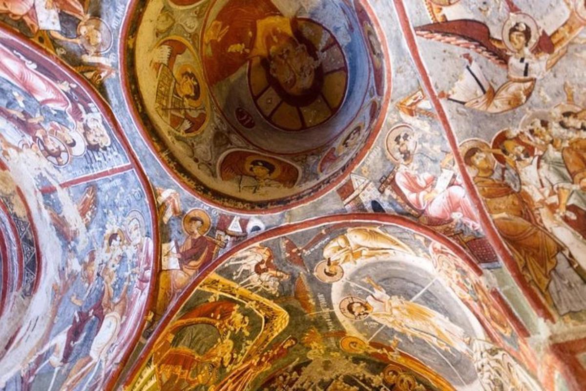 a ceiling with paintings of angels and churches