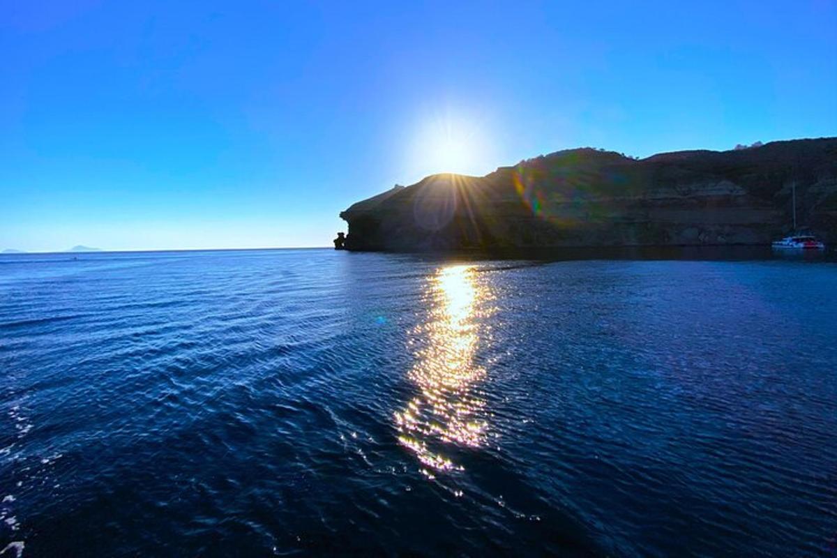 a large body of water with the sun shining on it