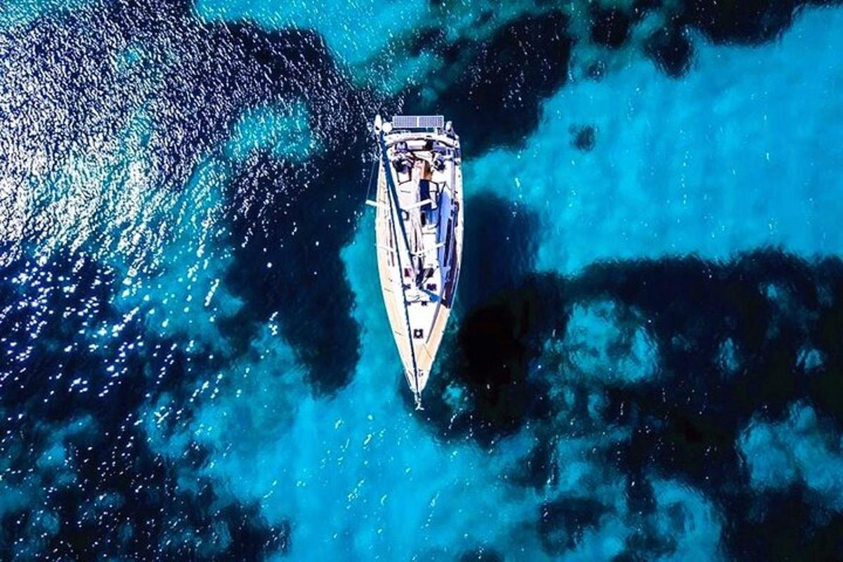 an aerial view of a boat in the ocean