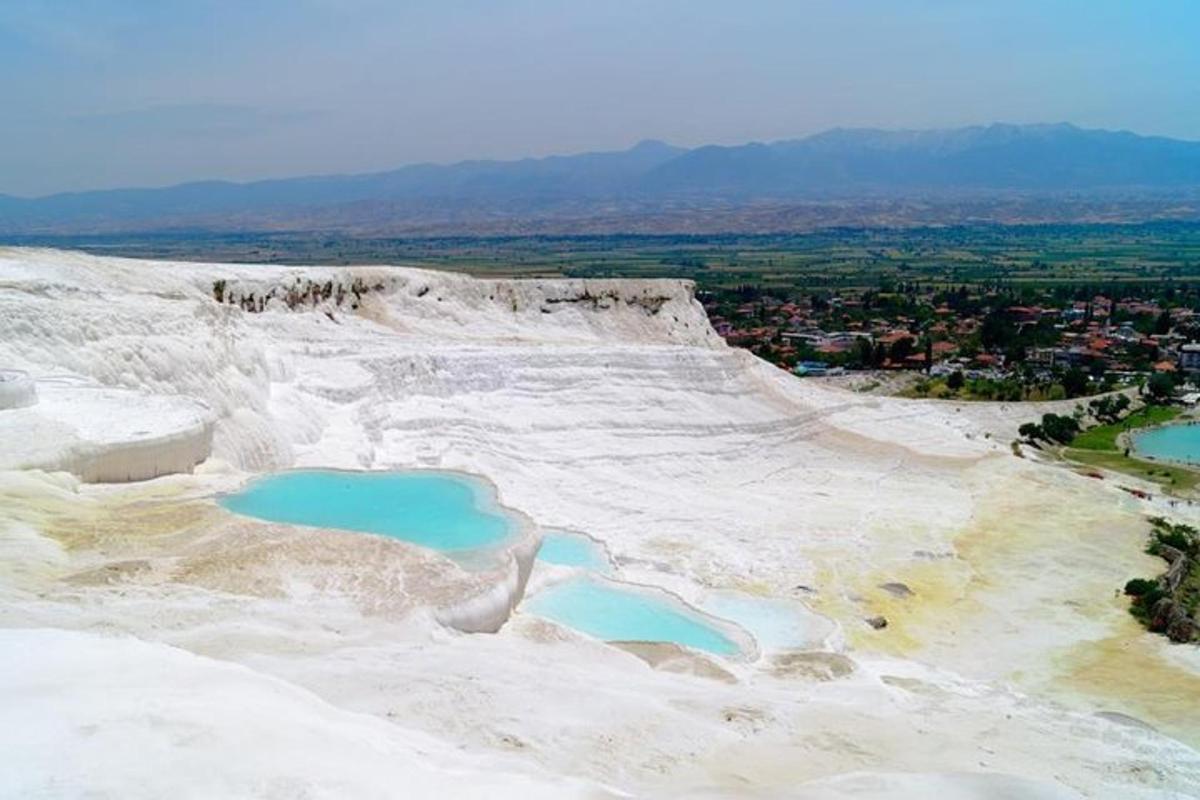 two blue pools of water on the side of a hill