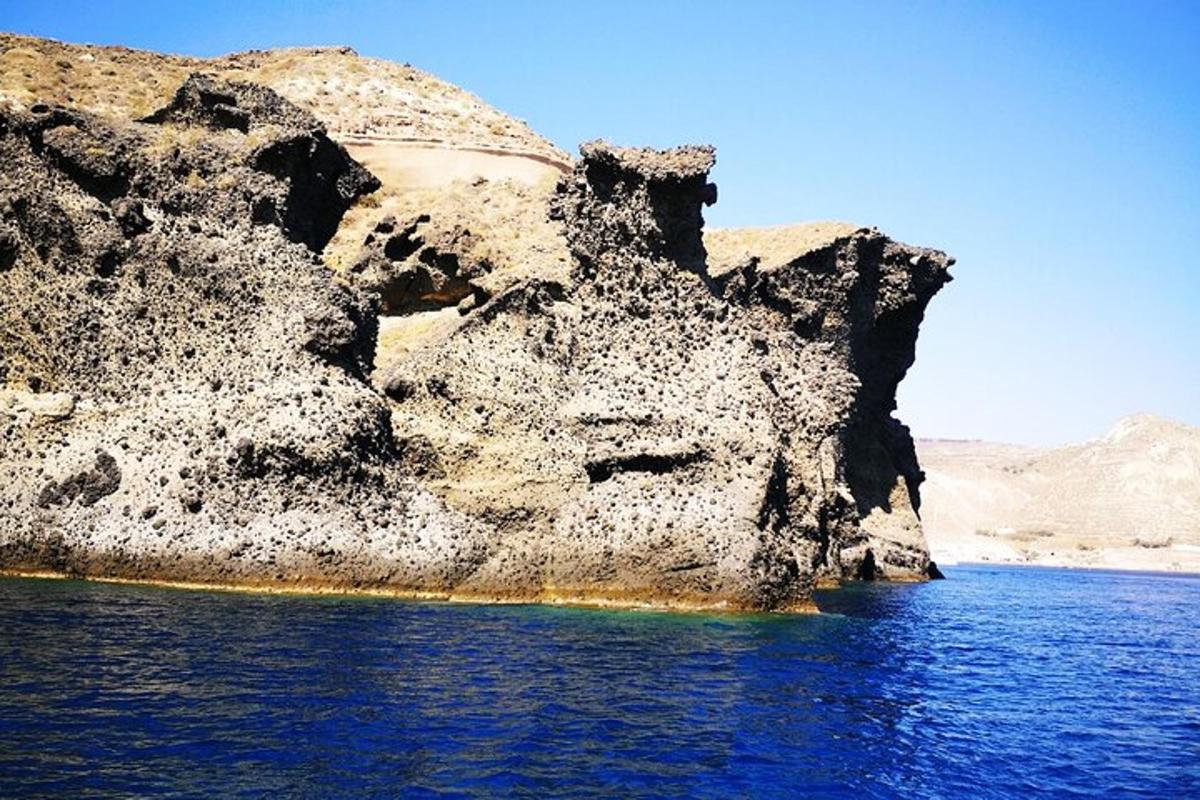 a large rock formation in the middle of the water