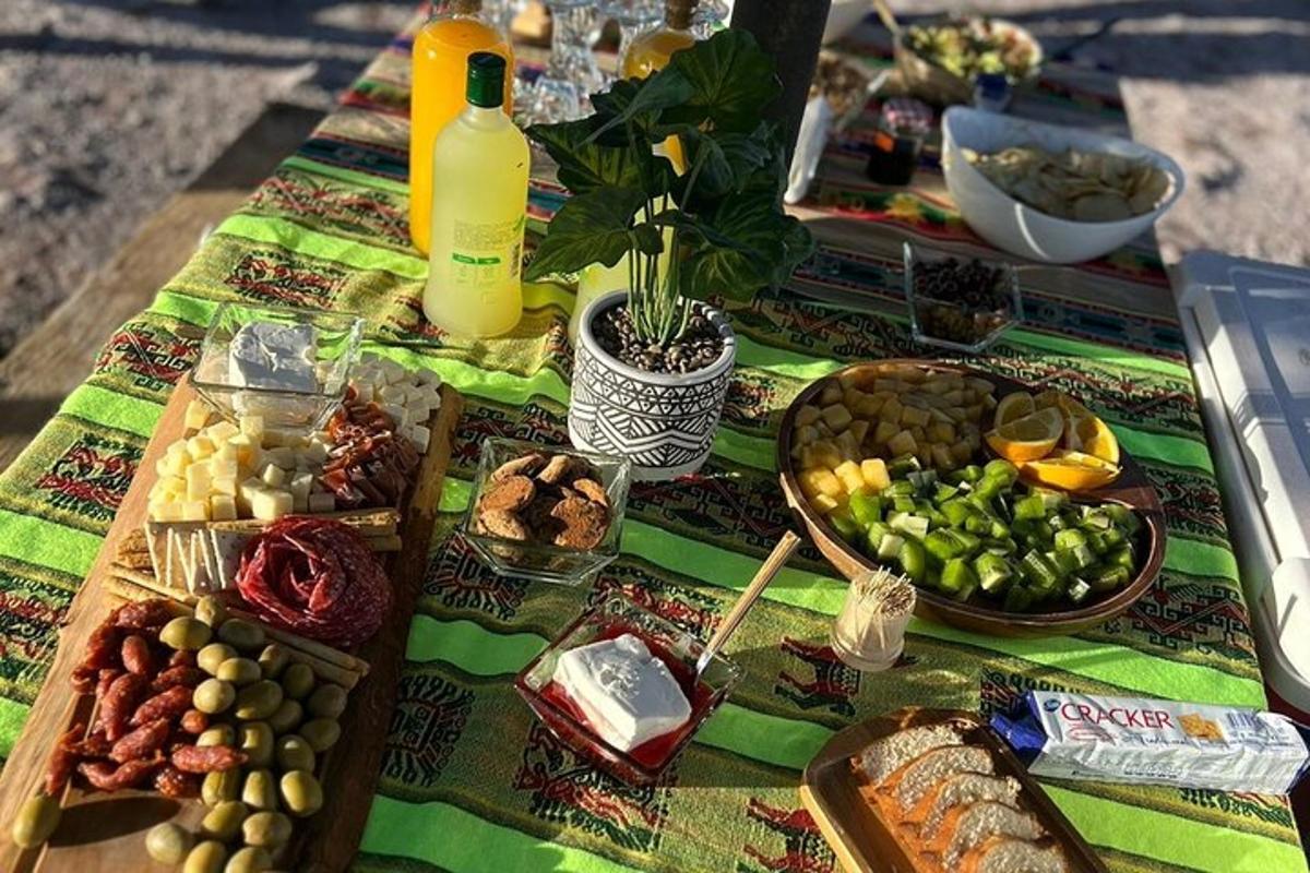 a picnic table with food and drinks on it