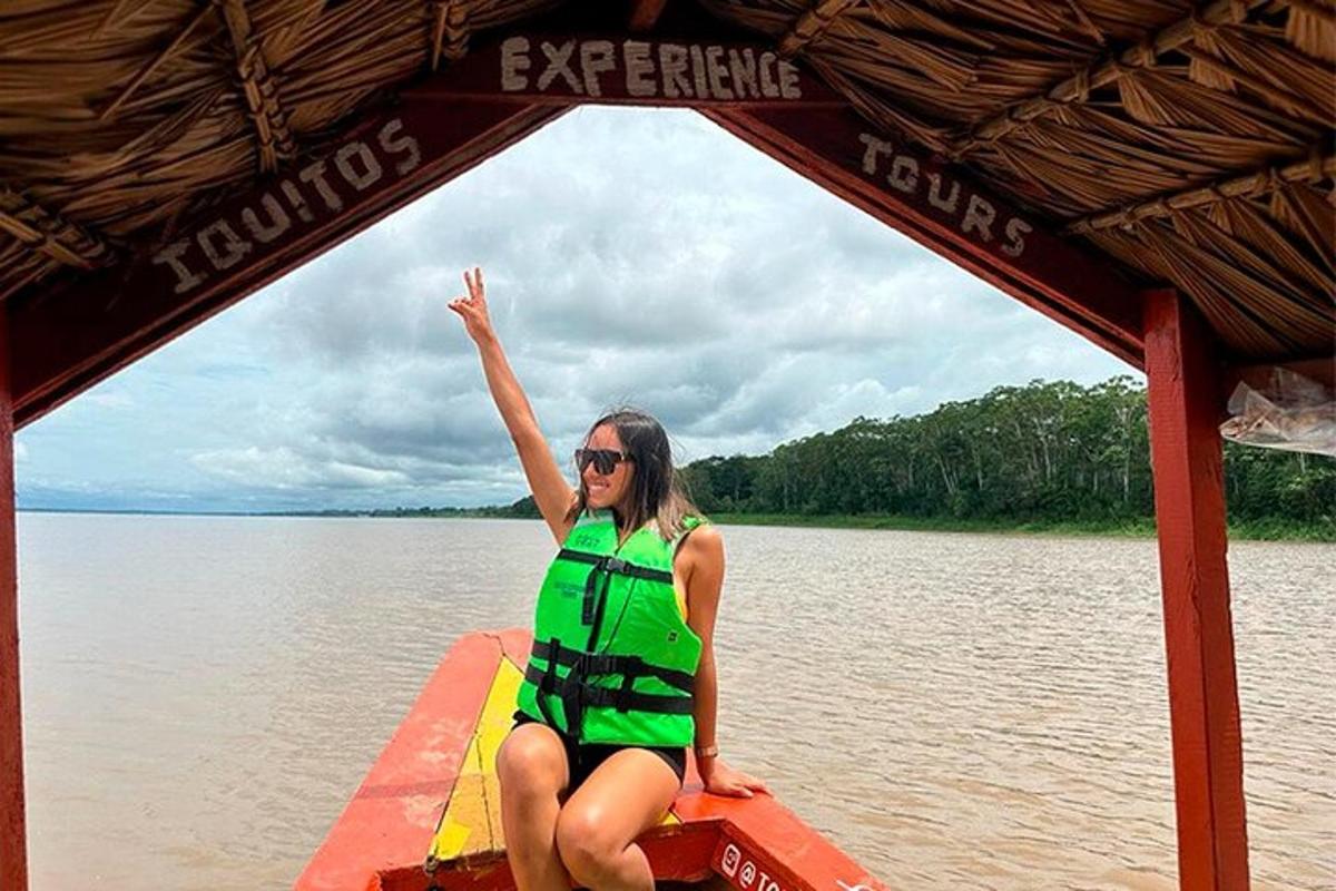 a woman in a life vest on a boat on the water