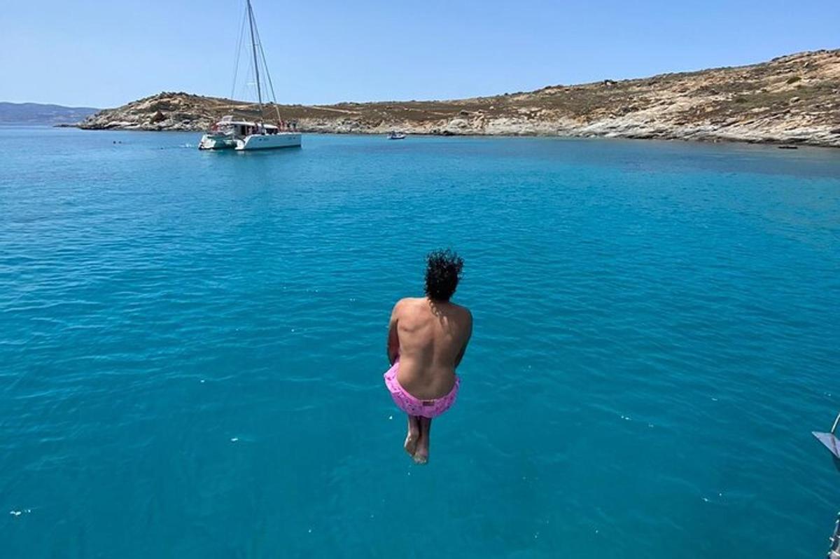 a man jumping into the water in the ocean