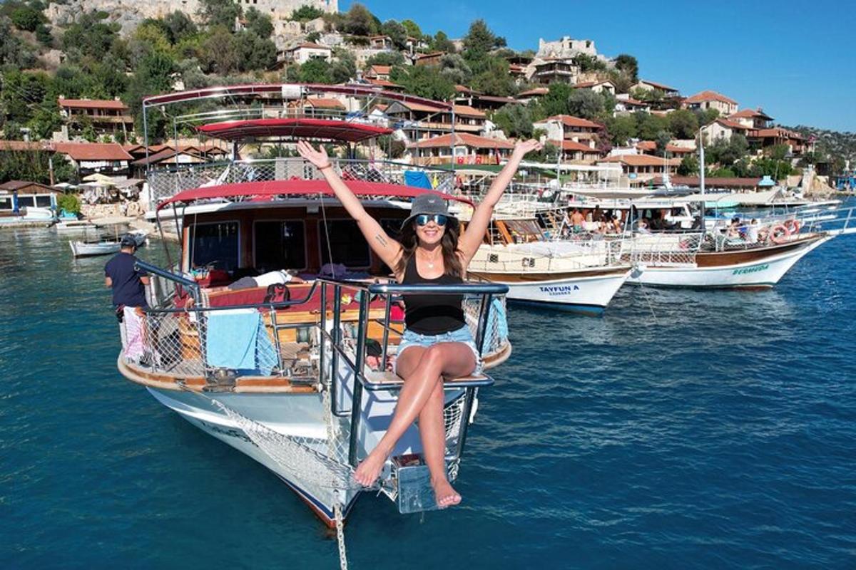 a woman is sitting on a boat in the water
