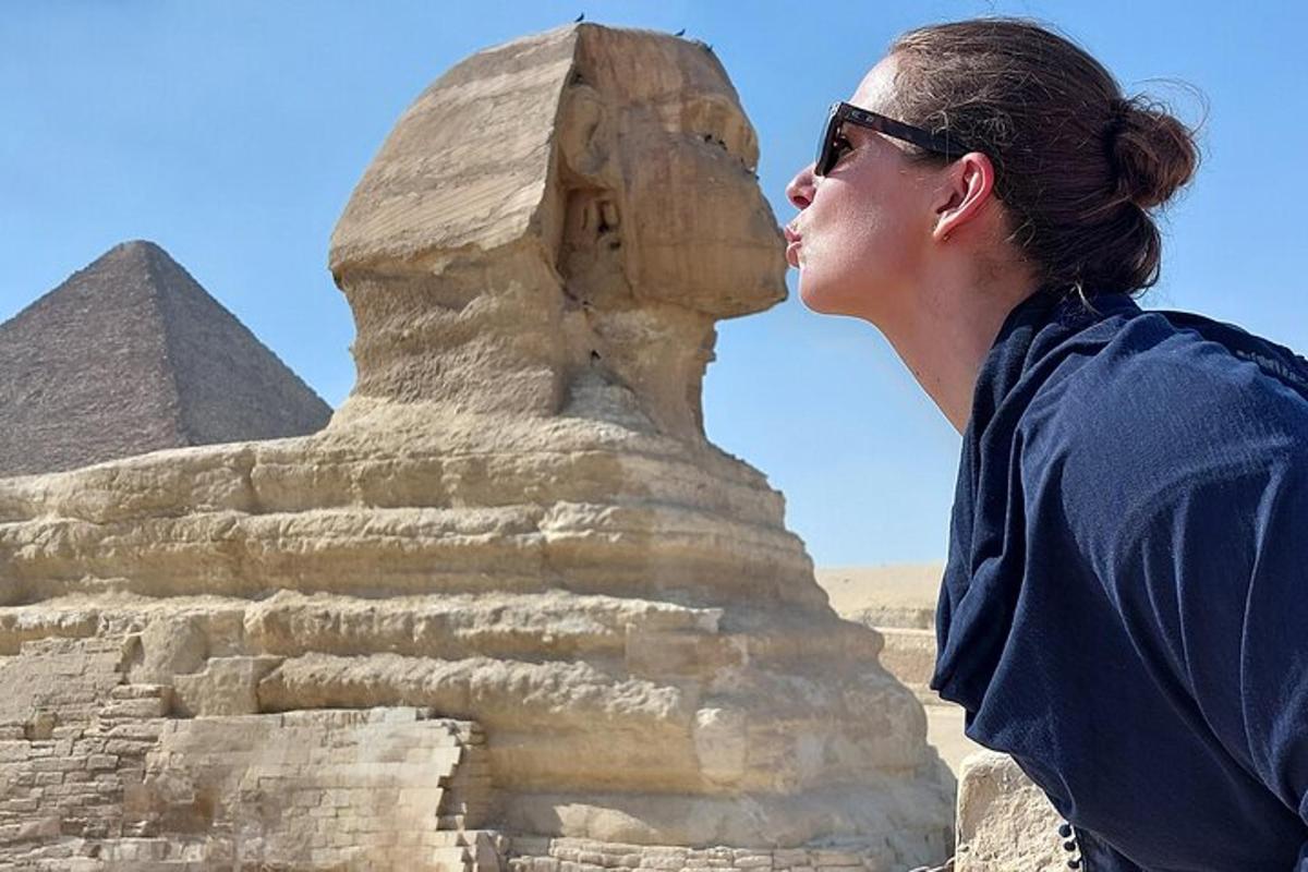a woman standing in front of the pyramids