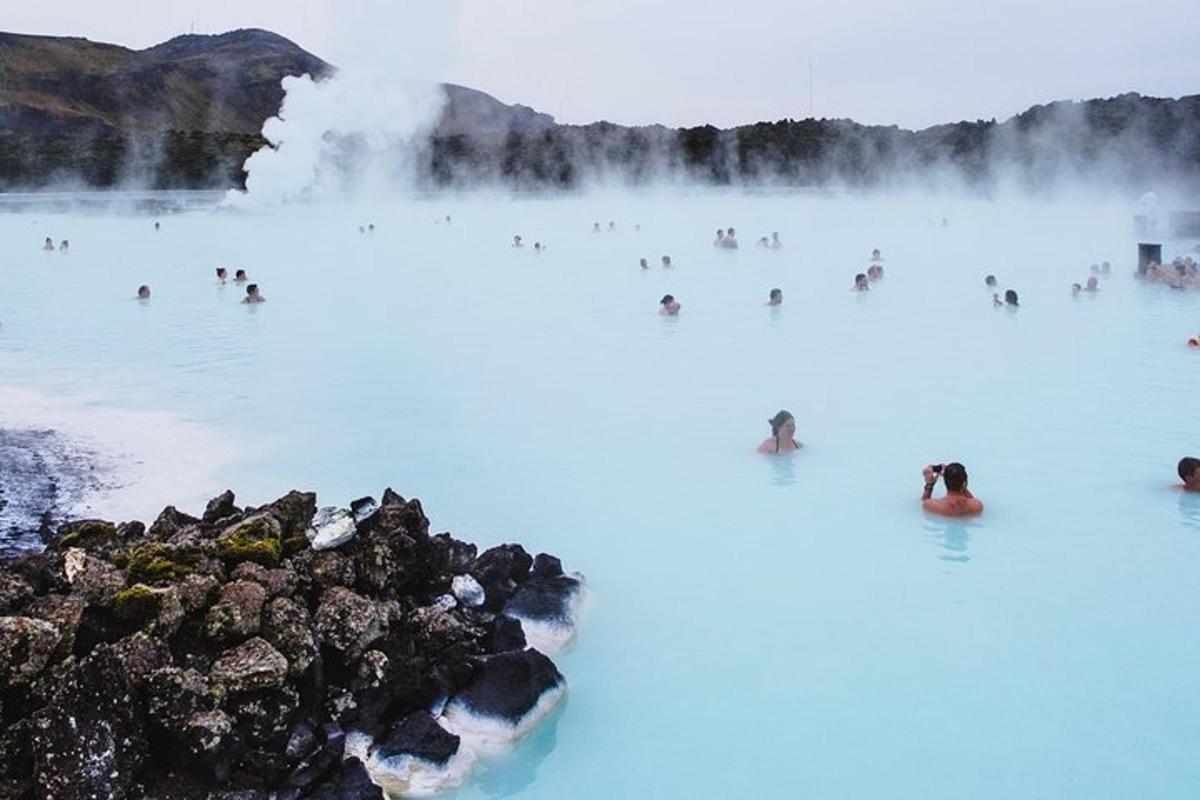 a group of people swimming in the blue lagoon