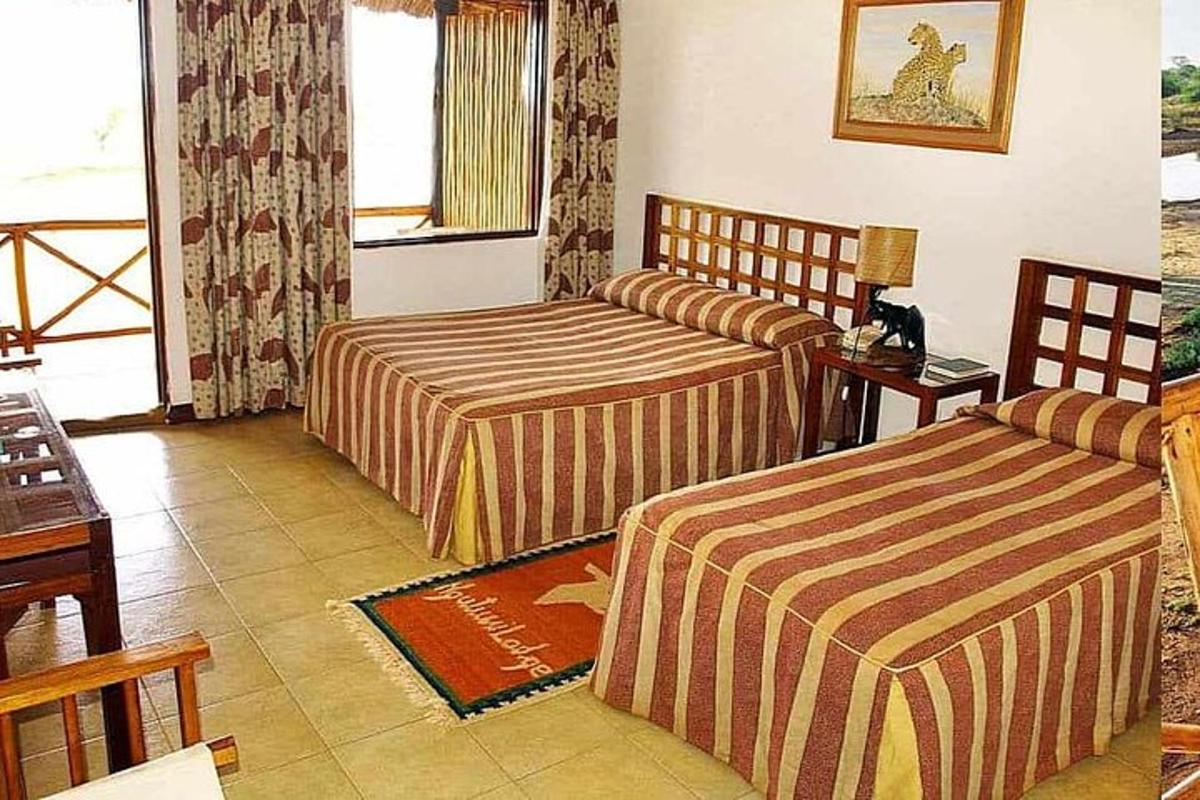 a hotel room with two beds and a table