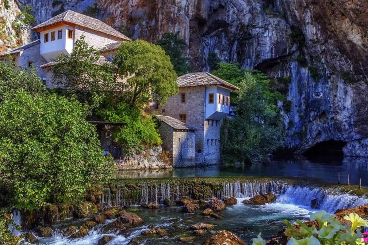 un edificio en medio de un río con una cascada
