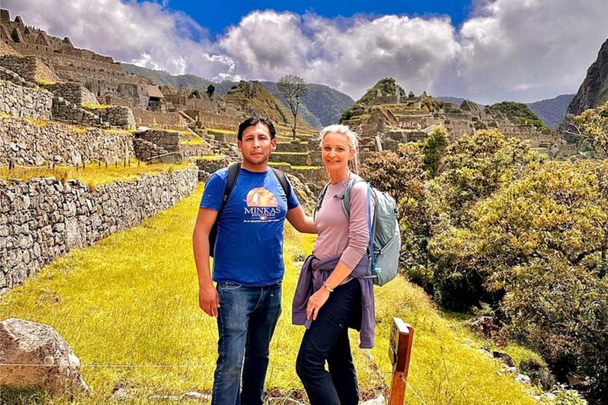 a man and a woman standing on a mountain