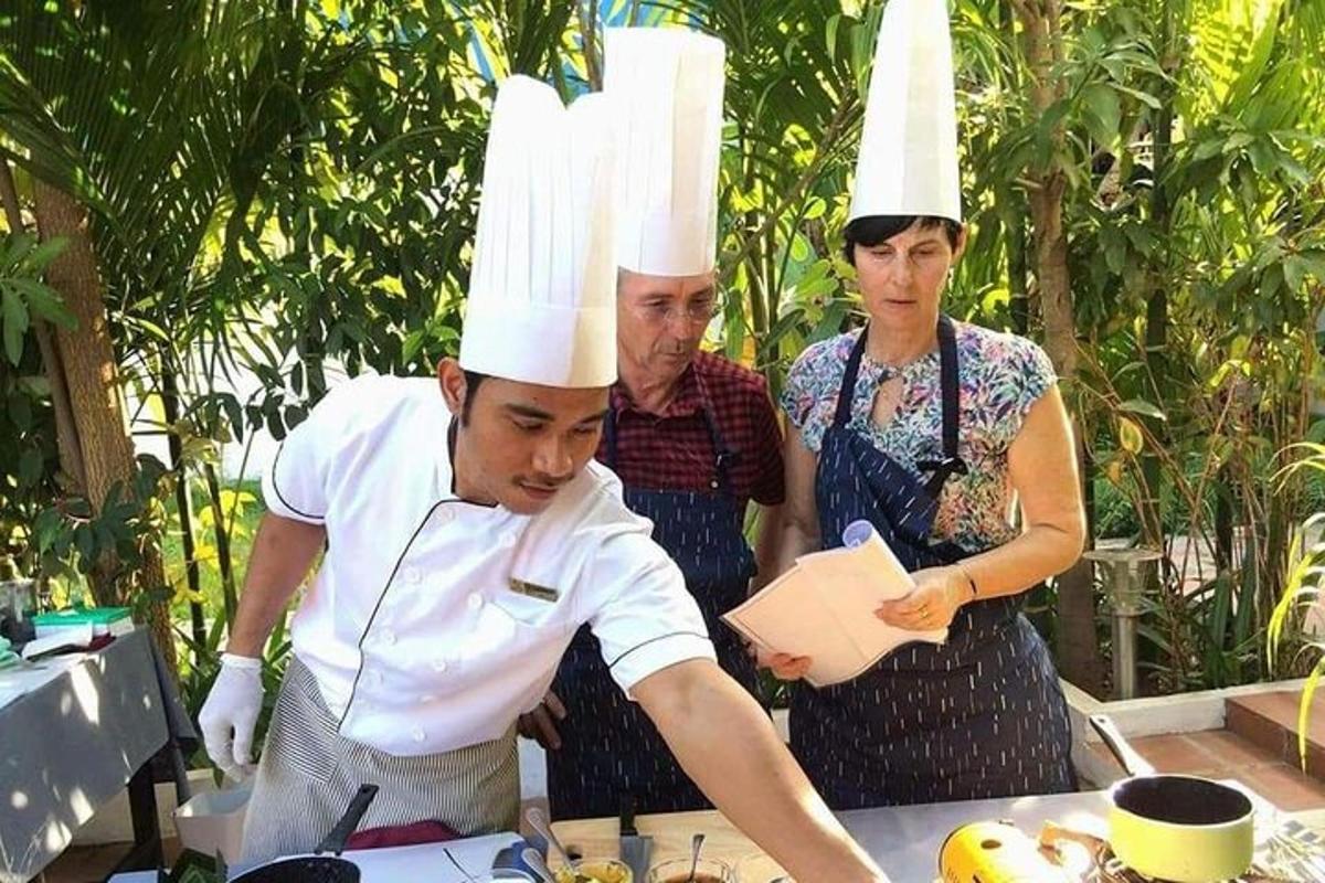 a man in chefs hats standing at a table