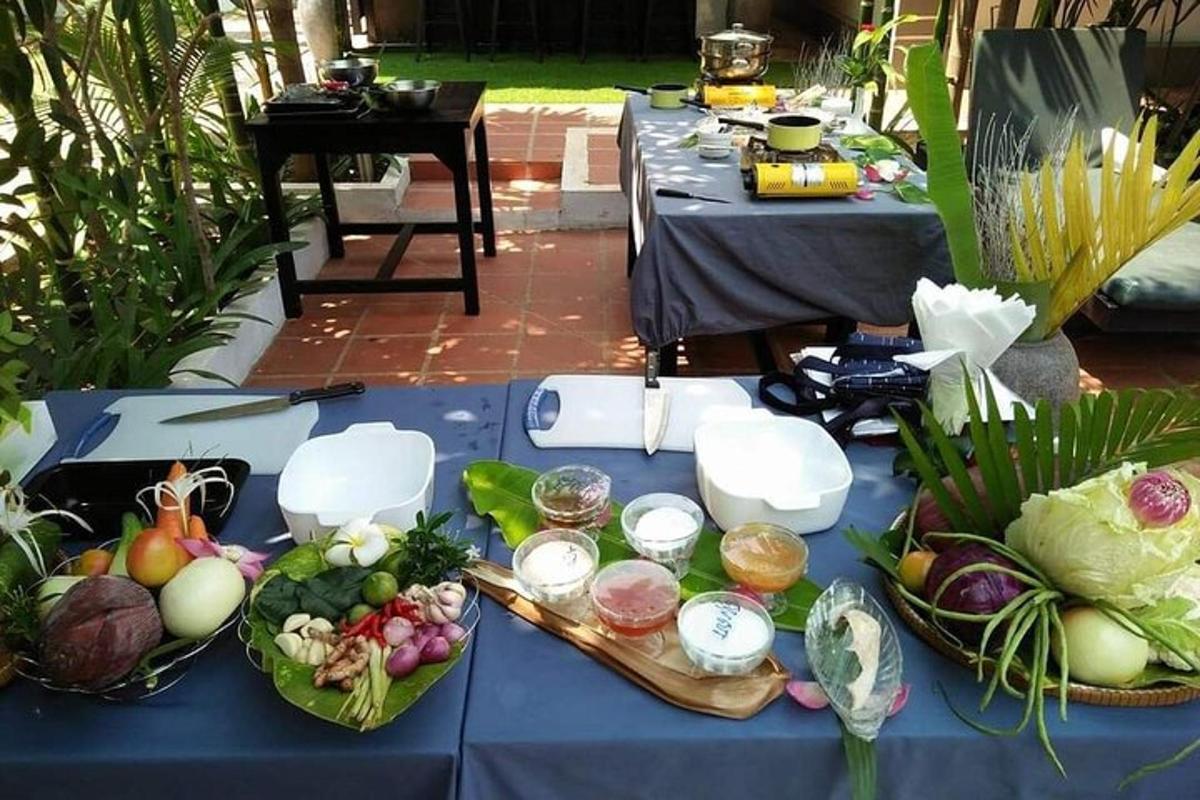 a blue table with bowls of fruits and vegetables on it