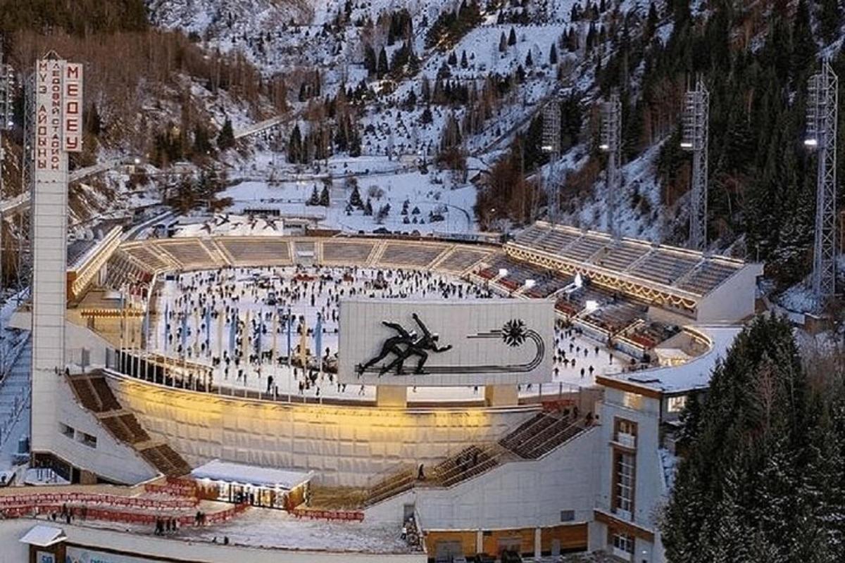 a large stadium with a clock in the middle of it